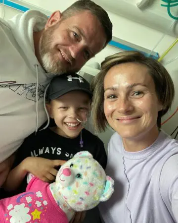 A photo of Kara with her parents when her final chemo finished