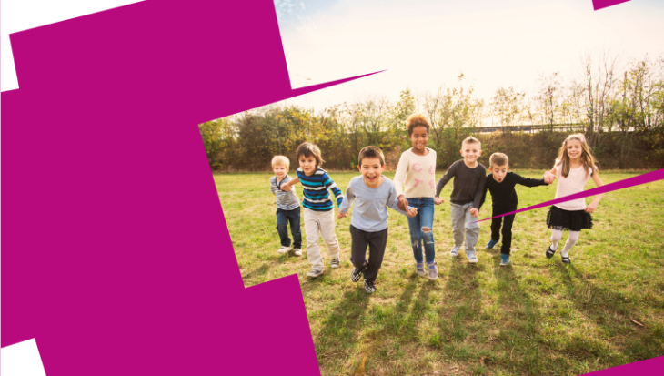 Web banner. image shows a group of 7 children all holding hands in a line, running towards the camera, smiling and looking excited