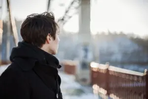 Young man standing on the bridge